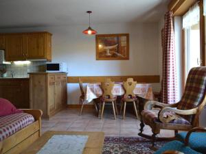 a living room with a kitchen and a table and chairs at Appartement Le Grand-Bornand, 3 pièces, 6 personnes - FR-1-241-177 in Le Grand-Bornand