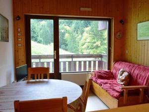 a room with a couch and a table and a window at Appartement Le Grand-Bornand, 1 pièce, 4 personnes - FR-1-241-170 in Le Grand-Bornand