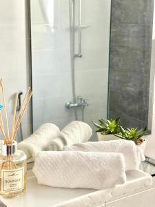 a row of towels on a counter in a bathroom at Iconic 4-bedroom villa with pool in Fujairah Palm in Fujairah