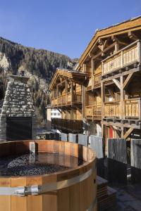 a resort with a hot tub in front of a building at Polaris 1 005 - LUXE & SKI LIFT apartment 6 pers in Zinal