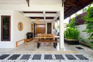 a patio with a wooden table and chairs at Villa Lunacasa, Modern Comfort in Balinese Style, 500m to beach in Seminyak