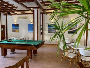 a billiard room with a pool table and chairs at Zak Inn in Hurghada