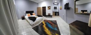 a room with a bed and a rug on the floor at Guesthouse Serenity in Hartbeespoort