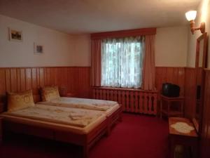 a bedroom with a large bed and a window at Matsureva House - Pri Ivan in Bansko