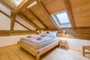 a bedroom with a bed in a room with wooden ceilings at Ferienwohnung Weitblick in Eggstätt