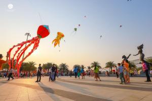 a group of people flying kites in a square at Vinhomes Ocean Park Gia Lam by QMP in Hanoi