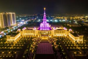 a building lit up in purple at night at Vinhomes Ocean Park Gia Lam by QMP in Hanoi