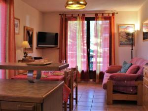 a living room with a couch and a table at Appartement au pied des pistes avec balcon à Risoul - FR-1-330-146 in Risoul