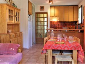 a dining room with a table and a kitchen at Appartement au pied des pistes avec balcon à Risoul - FR-1-330-146 in Risoul