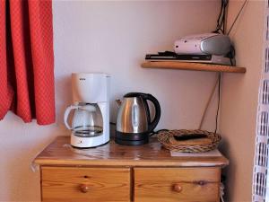 a coffee maker on top of a wooden dresser at Appartement cosy avec 5 couchages, centre de station Risoul 1850, proche remontées et commerces - FR-1-330-162 in Risoul