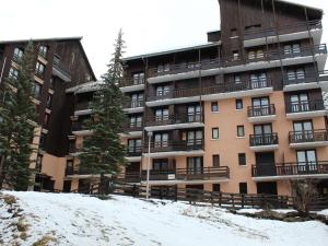 a large apartment building with snow in front of it at Studio cosy au pied des pistes - 4 couchages - Proche ESF et commerces - FR-1-330-175 in Risoul