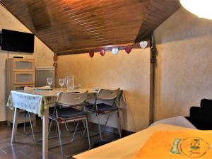 a dining room with a table and chairs with wine glasses at Appartement pieds des pistes, 2 cabines, 4 personnes - Risoul 1850 - FR-1-330-173 in Risoul