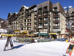 a large apartment building with chairs in the snow at Appartement 2 Pièces 6 Couchages, Pied de Pistes, Exposé Sud, Animaux Admis - FR-1-330-214 in Risoul