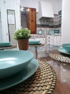 a kitchen with blue plates on a table at Apartamentos miradores de granada in Granada
