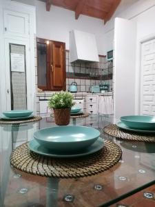 a kitchen with green plates on a glass table at Apartamentos miradores de granada in Granada
