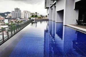 a blue swimming pool on top of a building at Avengers Crib 3BR Near KLCC in Kuala Lumpur