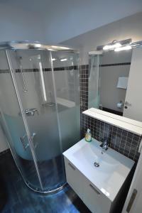 a bathroom with a shower and a white sink at Apartments Milanović in Mali Lošinj +32 photos