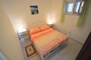 a bedroom with a bed with two night stands at Apartments Milanović in Mali Lošinj
