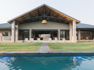 a house with a swimming pool in front of it at The Orpen Kruger in Welverdiend