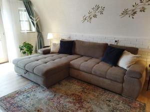 a brown couch sitting in a living room at Boti Hill Natural in Tihany