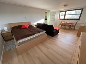 a bedroom with a bed and a living room at Apartament Pod Lipą in Wrocław