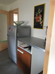 a kitchen with a counter and a refrigerator at Ferienwohnung Kopf in Schuttertal