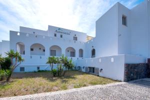 a white building with trees in front of it at Anessis in Fira