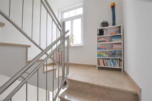 una escalera en una casa con un estante de libros en FeWo 1 "Birkenast" 1OG inkl Strandkorb, en Dahme