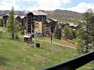 a view from a balcony of a large apartment building at Studio 4 couchages à Risoul 1850 - pied de pistes, calme, balcon exposé Sud - FR-1-330-58 in Risoul +11 photos