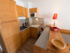 a small kitchen with a table with a lamp on it at Appartement Vars, 4 pièces, 6 personnes - FR-1-330B-31 in Vars