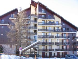 a large building with balconies on the side of it at Studio coin montagne calme, 4 pers, parking, Risoul 1850 - FR-1-330-92 in Risoul
