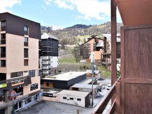 a view from a balcony of a city with buildings at Studio 4 pers proche remontées, commerces, animaux admis - Risoul 1850 - FR-1-330-123 in Risoul