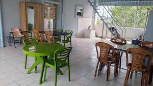 a green table and chairs in a room at Hotel Grand Stay in Tiruchchirāppalli