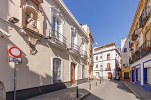 een straat in een oude stad met gebouwen bij Sevilla Flats in Sevilla