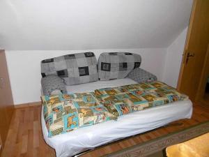 a bed with a blanket on top of it in a room at Rügen Fewo 38 in Dreschvitz
