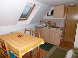 a small kitchen with a table and a sink at Rügen Fewo 38 in Dreschvitz +1 photo