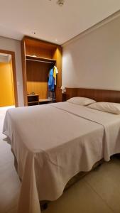 a bedroom with a large white bed in a room at Salinas Exclusive Resort - Apto 1Q in Salinópolis