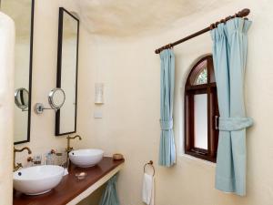 a bathroom with two sinks and a mirror at Olarro Plains in Masai Mara