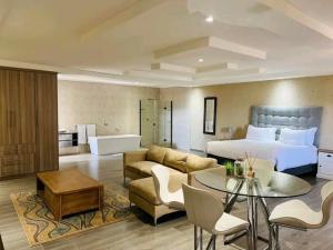 a hotel room with a bed and a living room at THE BRIDGE BOUTIQUE LODGE in Moletlane
