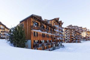 a large building in the snow with snow at Luxury Chalet with sauna by Avoriaz Chalets in Avoriaz