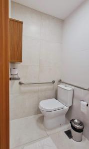 a bathroom with a white toilet in a room at Salinas Exclusive Resort - Apto 1Q in Salinópolis