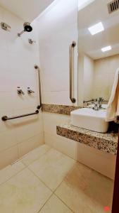 a bathroom with a sink and a shower at Salinas Exclusive Resort - Apto 1Q in Salinópolis