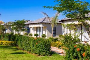 a house with a garden in front of it at THE BRIDGE BOUTIQUE LODGE in Moletlane