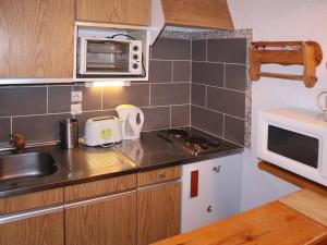 a small kitchen with a sink and a microwave at Studio Les Orres, 1 pièce, 4 personnes - FR-1-322-246 in Les Orres