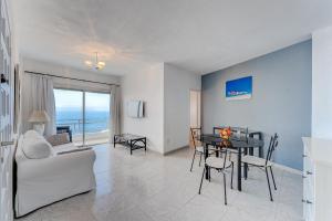 - un salon avec un canapé blanc et une table dans l'établissement Incredible Sea & Mountain View AirCon Front Line of Atlantic Ocean, à Puerto de Santiago
