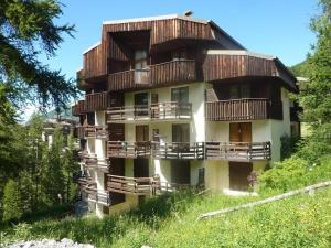 a building with wooden balconies on the side of it at Appartement Les Orres, 1 pièce, 6 personnes - FR-1-322-226 in Les Orres