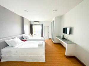 a hotel room with two beds and a television at The Island Resort in Bangkok