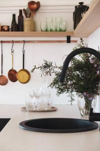 a kitchen counter with a sink and a sink at Quaint and intimate 1-bed seaside cottage in Bridport