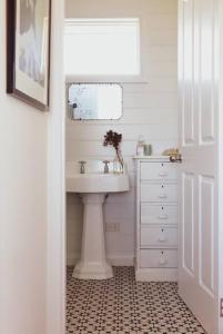 a white bathroom with a sink and a mirror at Quaint and intimate 1-bed seaside cottage in Bridport +38 photos