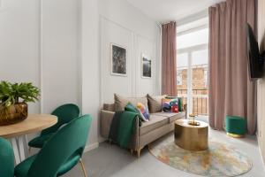 a living room with a couch and a table at Movo Old Town Apartments in Warsaw